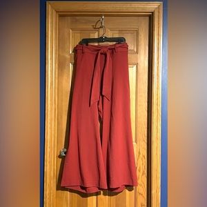 Burnt-orange, wide-leg LB trousers with tie belt.